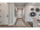 Bright entryway featuring hardwood floors, modern artwork, and a view into the dining area at 14160 Bunny Hop Ln, Parker, CO 80134