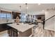 Open-concept kitchen with an island, stainless steel sink, and view of the dining and living areas at 14160 Bunny Hop Ln, Parker, CO 80134