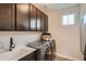 A clean and well-organized laundry room with modern appliances and storage space for convenience at 14160 Bunny Hop Ln, Parker, CO 80134