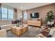 Comfortable living room with a large window, stylish furniture, and a modern media center at 14160 Bunny Hop Ln, Parker, CO 80134