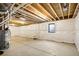 Unfinished basement with white plastic on walls and a small window at 4101 S Lincoln St, Englewood, CO 80113