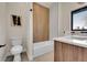 Bathroom showcasing a tiled bathtub and modern fixtures; natural light from the window at 4101 S Lincoln St, Englewood, CO 80113