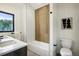 Modern bathroom featuring a shower/tub combo, white tile, and a double vanity at 4101 S Lincoln St, Englewood, CO 80113