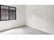 A bright, empty bedroom with neutral carpet and a large window at 4101 S Lincoln St, Englewood, CO 80113