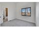 Bright bedroom with a large window and neutral carpet, ready for personal touches at 4101 S Lincoln St, Englewood, CO 80113