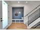 Inviting entryway with a built-in bench, coat hooks, and stylish decor adjacent to a staircase at 4101 S Lincoln St, Englewood, CO 80113