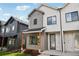 Modern townhome featuring mixed siding, a covered entry, and sleek black window frames at 4101 S Lincoln St, Englewood, CO 80113