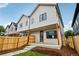 Exterior view of a modern home with light siding, a fenced yard, and covered entry porch at 4101 S Lincoln St, Englewood, CO 80113