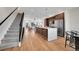 Modern kitchen featuring a large island with bar seating, stainless steel appliances, and light wood floors at 4101 S Lincoln St, Englewood, CO 80113