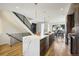 Modern kitchen with a large center island, stainless steel appliances, and adjacent dining area at 4101 S Lincoln St, Englewood, CO 80113