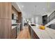 Stylish kitchen featuring wood cabinets, stainless steel appliances, and a large island with a sink at 4101 S Lincoln St, Englewood, CO 80113