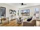 Bright living room featuring hardwood floors, modern furnishings and large window for natural light at 4101 S Lincoln St, Englewood, CO 80113