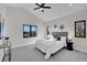 Vaulted ceiling bedroom with a ceiling fan, carpet, and a bright view from three modern windows at 4101 S Lincoln St, Englewood, CO 80113