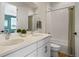 Bathroom featuring a double sink vanity with white cabinets and a shower-tub with curtain at 455 Rogers Way, Castle Rock, CO 80104