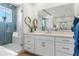 Bright bathroom with large mirror, double sink vanity, frameless shower, and modern fixtures at 455 Rogers Way, Castle Rock, CO 80104