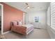 Cozy bedroom featuring a ceiling fan, plush bedding, and white shutters, offering a relaxing retreat at 455 Rogers Way, Castle Rock, CO 80104