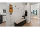 Functional entryway featuring a storage bench, coat hooks, and decorative wall art and access to laundry room at 455 Rogers Way, Castle Rock, CO 80104