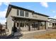 Stunning two-story home boasting a covered patio, gravel landscaping, and expansive backyard on a sunny day at 455 Rogers Way, Castle Rock, CO 80104