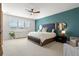 Stylish main bedroom features a decorative accent wall, large windows, and neutral-colored carpet at 455 Rogers Way, Castle Rock, CO 80104