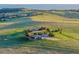 Aerial view of ranch property with outbuildings, barn and rolling hills at 1764 Mesa Ridge Ln, Castle Rock, CO 80108