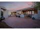 Charming back patio with brick flooring, covered lounge area, and stylish outdoor seating for relaxation at 1764 Mesa Ridge Ln, Castle Rock, CO 80108