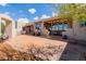 Inviting back patio with brick flooring, covered lounge area, and stylish outdoor seating for relaxation at 1764 Mesa Ridge Ln, Castle Rock, CO 80108