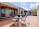 Inviting brick back patio with a porch swing, cozy seating, and well-manicured potted plants for outdoor enjoyment at 1764 Mesa Ridge Ln, Castle Rock, CO 80108
