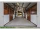 Interior shot of horse stalls in barn with center aisle at 1764 Mesa Ridge Ln, Castle Rock, CO 80108