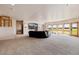 Spacious basement living area with large windows, comfortable seating, and entertainment center at 1764 Mesa Ridge Ln, Castle Rock, CO 80108