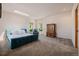 Large bedroom with plush carpeting, soft, natural lighting, and wooden armoire at 1764 Mesa Ridge Ln, Castle Rock, CO 80108