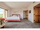 Bedroom with plush carpet, natural light from large windows, and calming decor creates a relaxing retreat at 1764 Mesa Ridge Ln, Castle Rock, CO 80108
