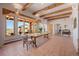 Open dining area with tile floors, wooden beams, and elegant furnishings, offering abundant natural light at 1764 Mesa Ridge Ln, Castle Rock, CO 80108