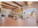 Open dining area with wooden beams, tile floors, large windows, and elegant furnishings at 1764 Mesa Ridge Ln, Castle Rock, CO 80108