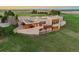 Stunning exterior elevation showcases a modern stucco home with a deck, hot tub, and scenic views in the countryside at 1764 Mesa Ridge Ln, Castle Rock, CO 80108