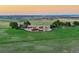 Long distance exterior view of ranch home nestled on sprawling green acreage at 1764 Mesa Ridge Ln, Castle Rock, CO 80108