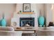 Close-up of the living room's fireplace with a wooden mantel and decorative accents at 1764 Mesa Ridge Ln, Castle Rock, CO 80108
