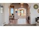 Bright hallway with tile floors, arched doorways, and large windows showing beautiful views at 1764 Mesa Ridge Ln, Castle Rock, CO 80108
