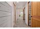 Bright hallway with wood-trimmed doorways, ample storage, and neutral carpet provides access to other rooms at 1764 Mesa Ridge Ln, Castle Rock, CO 80108