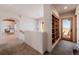Hallway features arched doorway, wooden beam ceiling and access to dining area and outdoor balcony at 1764 Mesa Ridge Ln, Castle Rock, CO 80108