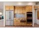Kitchen features wood cabinetry, stainless steel appliances, granite counters, and brick flooring at 1764 Mesa Ridge Ln, Castle Rock, CO 80108
