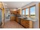 Bright kitchen features wood cabinetry, stainless steel appliances, and a large window with scenic views at 1764 Mesa Ridge Ln, Castle Rock, CO 80108