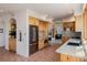 Spacious kitchen features stainless appliances, wood cabinetry, and brick flooring at 1764 Mesa Ridge Ln, Castle Rock, CO 80108