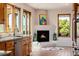 Living room featuring a fireplace, large windows, outdoor views, and kitchen area at 1764 Mesa Ridge Ln, Castle Rock, CO 80108