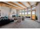 Spacious living room with high ceilings, exposed beams, and a cozy fireplace at 1764 Mesa Ridge Ln, Castle Rock, CO 80108