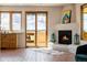 Open living space featuring a fireplace, access to an outdoor patio, and a sink at 1764 Mesa Ridge Ln, Castle Rock, CO 80108