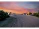 Exterior shot of outbuildings on property with vibrant sunset in the background at 1764 Mesa Ridge Ln, Castle Rock, CO 80108