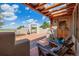 Scenic patio area featuring comfortable wooden seating with views of an archway and the surrounding landscape at 1764 Mesa Ridge Ln, Castle Rock, CO 80108