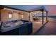 Outdoor patio with hot tub, dining set, and string lights for evening enjoyment at 1764 Mesa Ridge Ln, Castle Rock, CO 80108