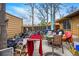 View of the backyard with an outdoor patio, red towel, grill, and patio furniture at 12458 E Kansas Pl, Aurora, CO 80012