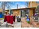 View of the backyard with an outdoor patio, red towel, grill, and table at 12458 E Kansas Pl, Aurora, CO 80012